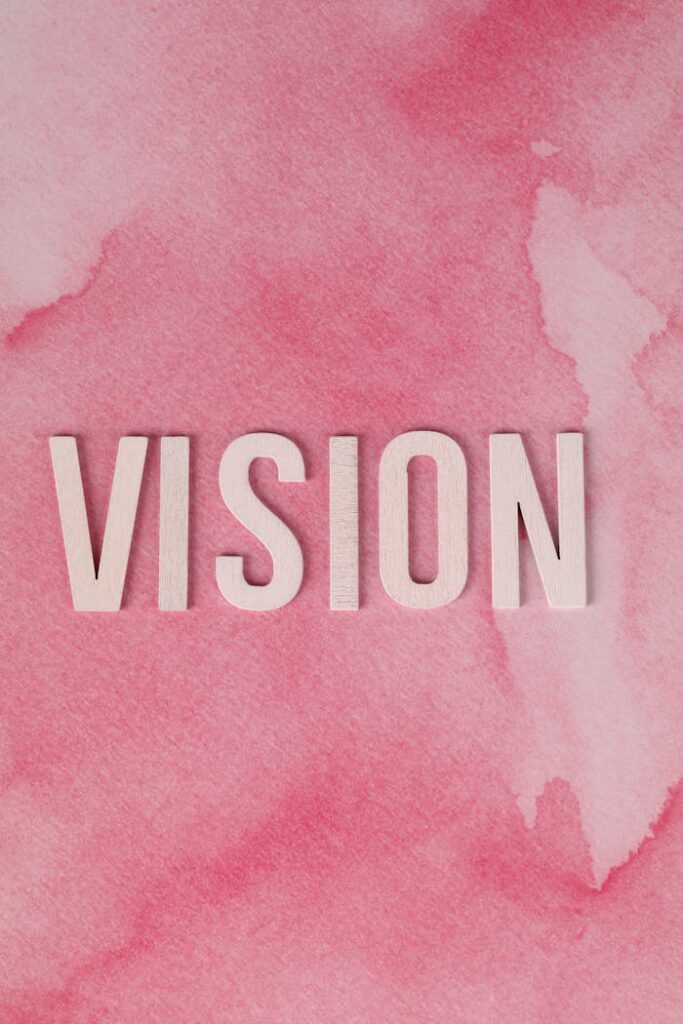 Crafting Captivating Headlines: Your awesome post title goes here Inspiring 'VISION' text on a pink watercolor backdrop for motivation.