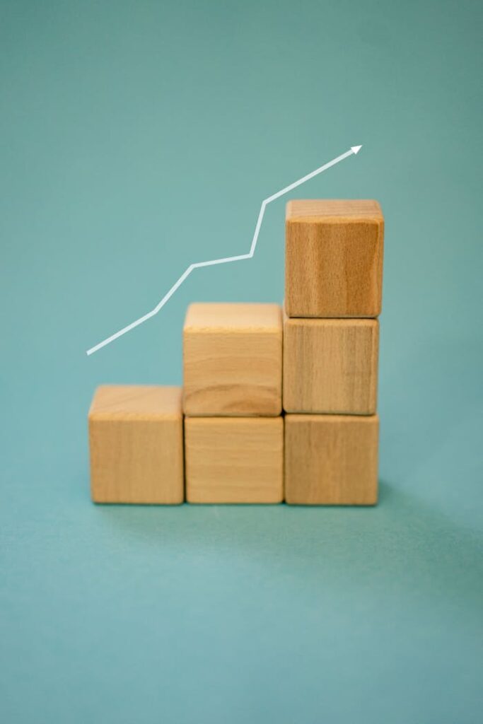 Mastering the First Impression: Your intriguing post title goes here Wooden blocks forming a staircase with an upward arrow symbolizing growth and progress.